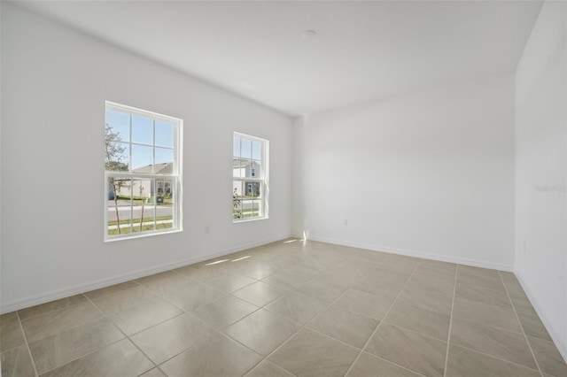 unfurnished room featuring light tile patterned flooring