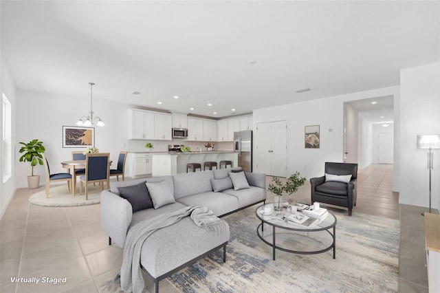 tiled living room featuring a chandelier