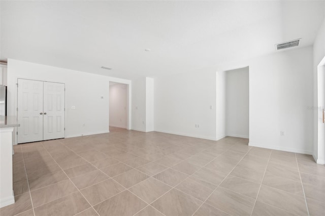 unfurnished living room featuring light tile patterned floors