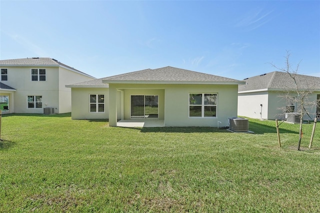 back of property with a patio, a yard, and central AC unit