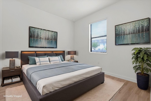 bedroom with light hardwood / wood-style floors