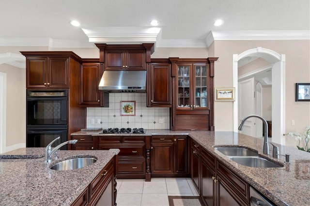 kitchen with ventilation hood, sink, tasteful backsplash, and black double oven