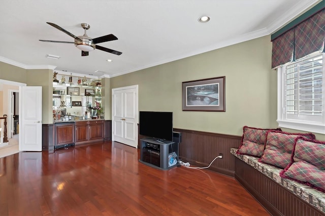 living room featuring dark hardwood / wood-style flooring, ornamental molding, and ceiling fan