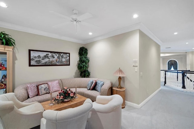 carpeted living room with ceiling fan and ornamental molding