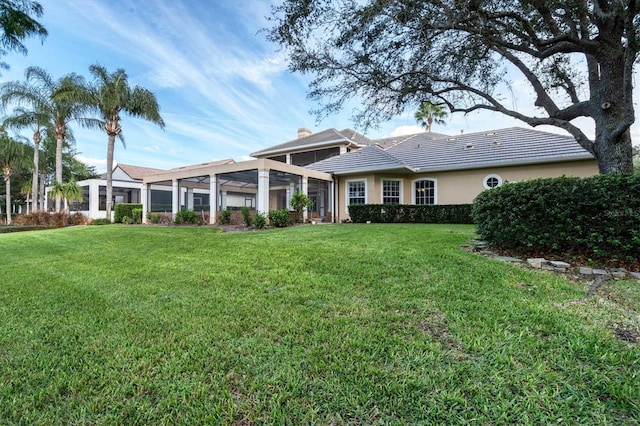 rear view of property featuring a yard