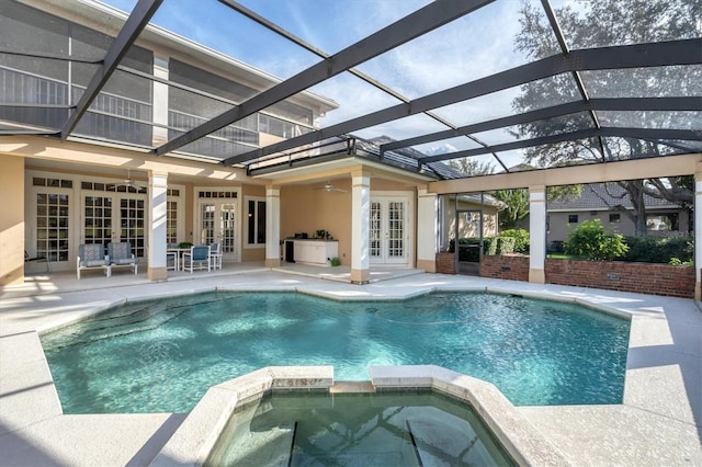 view of pool featuring an in ground hot tub, a patio, french doors, and a lanai