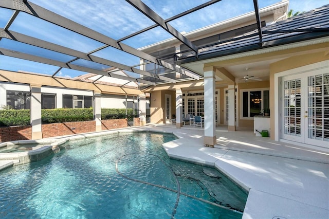 view of pool with ceiling fan, a lanai, french doors, and a patio