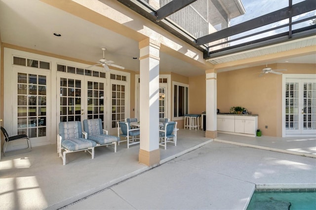 view of patio / terrace featuring ceiling fan and french doors