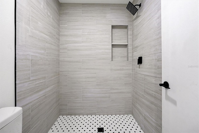 bathroom featuring a shower stall and toilet