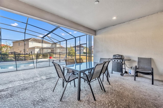 view of patio / terrace with grilling area and glass enclosure