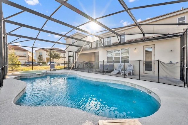 view of swimming pool with a lanai, a patio area, and an in ground hot tub