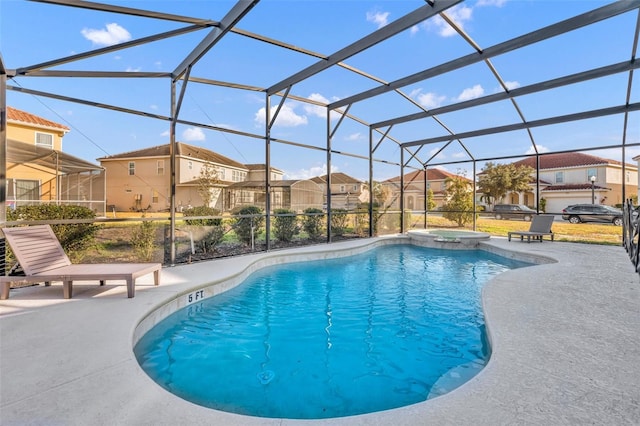 view of pool featuring a lanai, a patio area, and an in ground hot tub