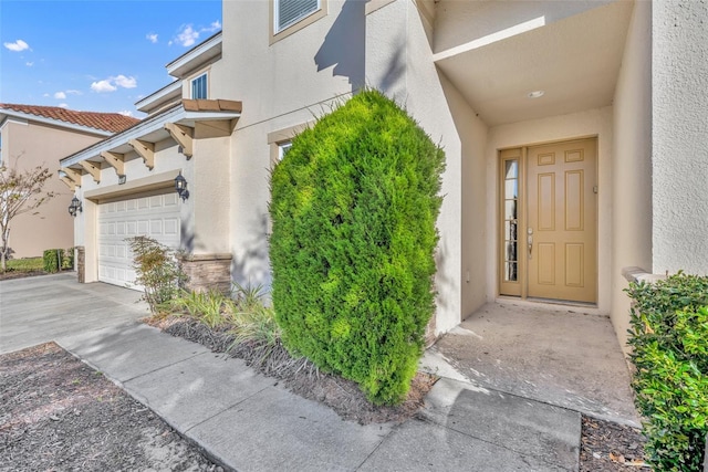 entrance to property with stucco siding