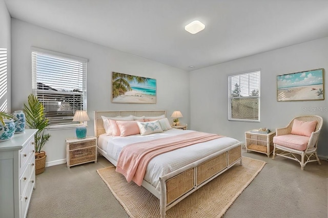 bedroom featuring baseboards and light colored carpet