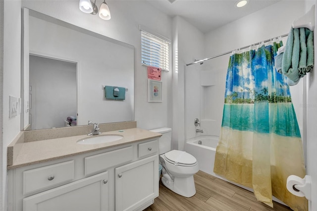 bathroom with wood finished floors, shower / bath combo, vanity, and toilet