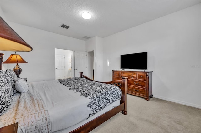 bedroom featuring baseboards, visible vents, a textured ceiling, and light colored carpet