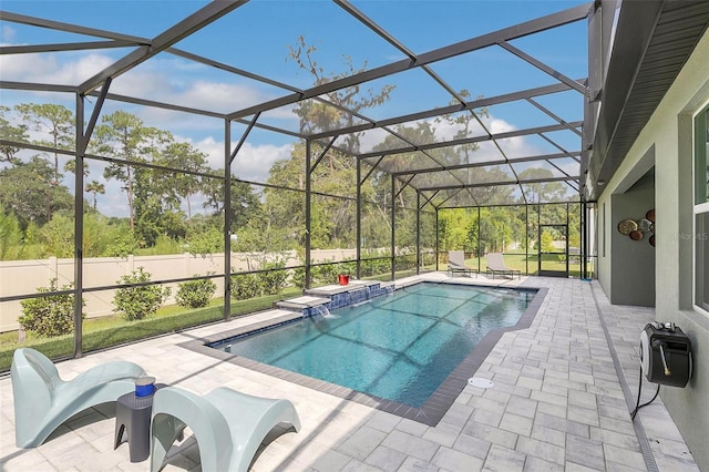 view of pool with pool water feature, a lanai, and a patio area