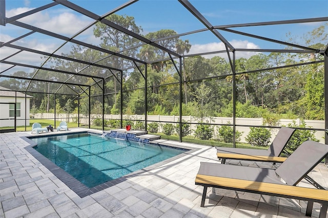 view of swimming pool with a patio and glass enclosure