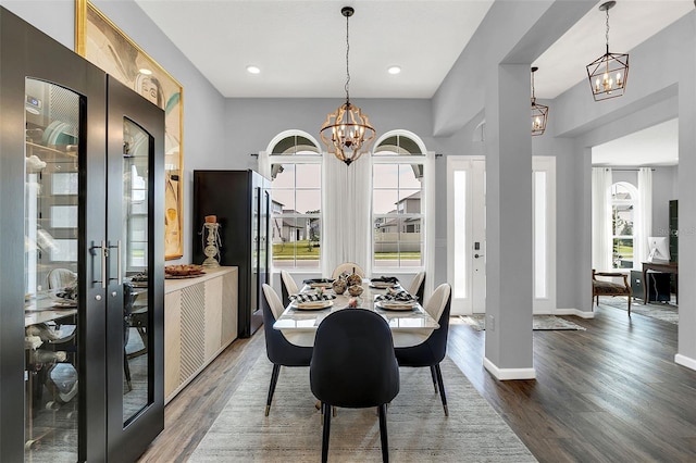 dining room with a notable chandelier, wood-type flooring, and french doors