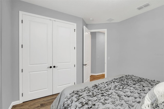 bedroom with a closet and hardwood / wood-style flooring