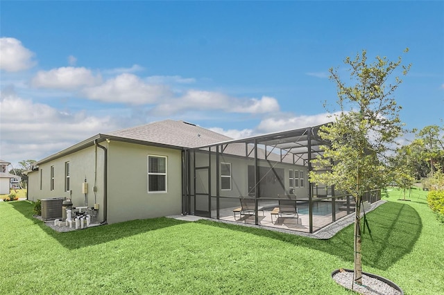 back of property featuring a lawn, a patio, a pool, and a lanai