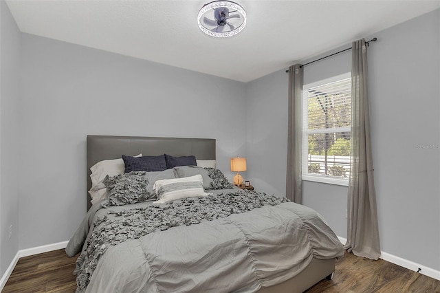 bedroom with dark hardwood / wood-style floors