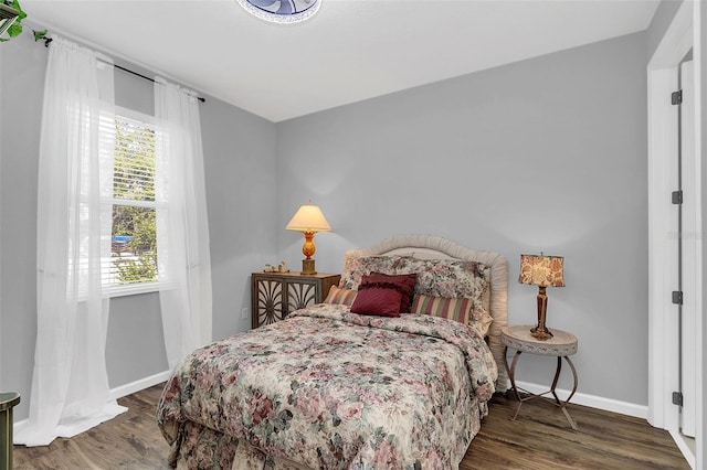 bedroom featuring hardwood / wood-style floors and multiple windows