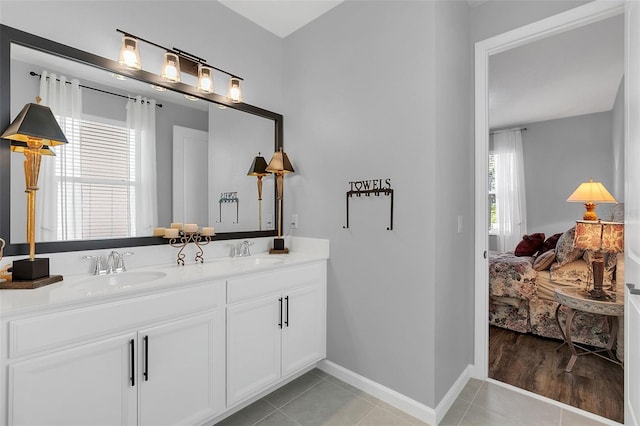 bathroom with dual bowl vanity and tile patterned flooring