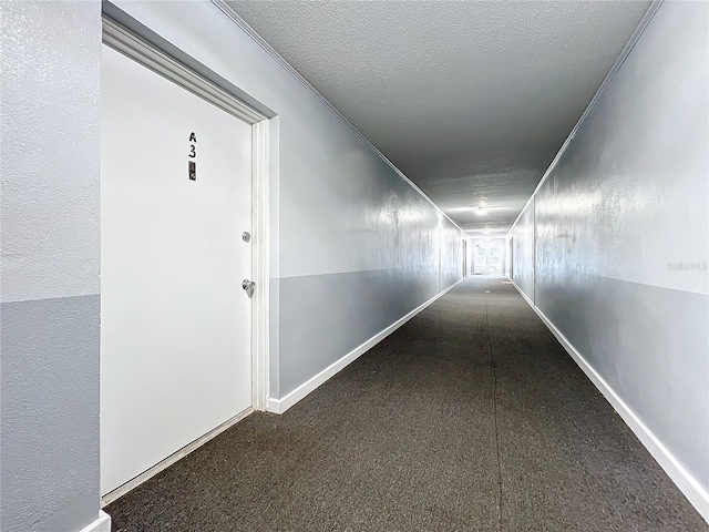 hall with a textured ceiling