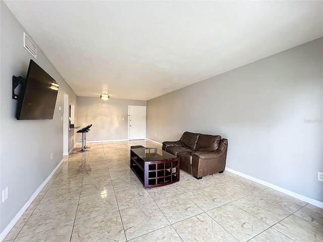 unfurnished living room featuring light tile patterned flooring