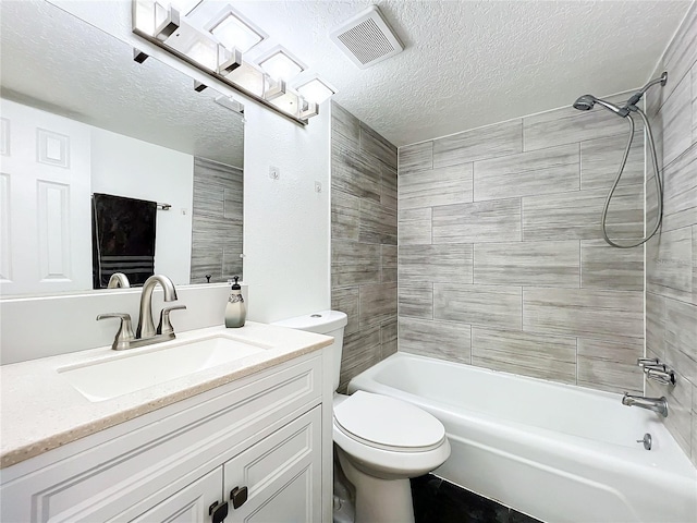 full bathroom featuring tiled shower / bath, toilet, a textured ceiling, and vanity