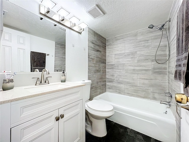 full bathroom featuring tiled shower / bath, a textured ceiling, tile patterned flooring, vanity, and toilet