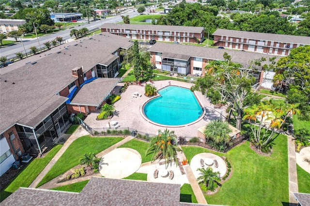 view of swimming pool featuring a patio area and a yard