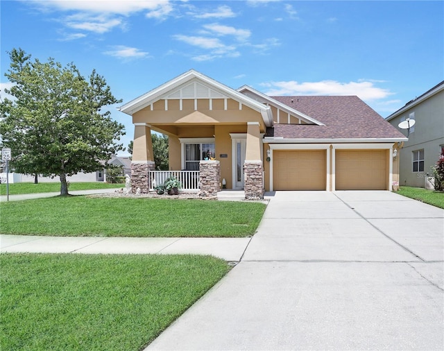 view of front facade featuring a garage, a front yard, and a porch