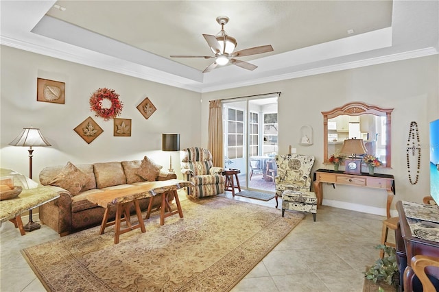 tiled living room featuring a tray ceiling, crown molding, and ceiling fan