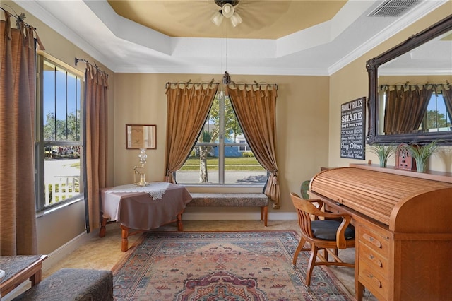 living area featuring light tile patterned floors, a tray ceiling, ceiling fan, and ornamental molding