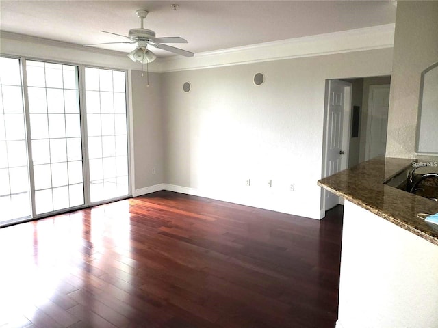 spare room featuring ceiling fan, ornamental molding, and dark hardwood / wood-style flooring