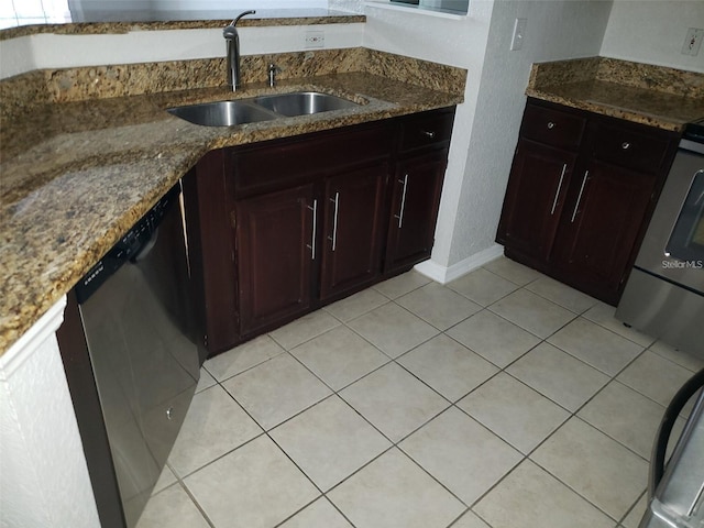 kitchen with dishwashing machine, light tile patterned flooring, a sink, and range