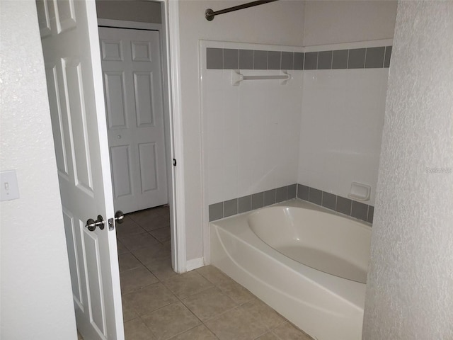 full bathroom featuring a tub to relax in and tile patterned flooring