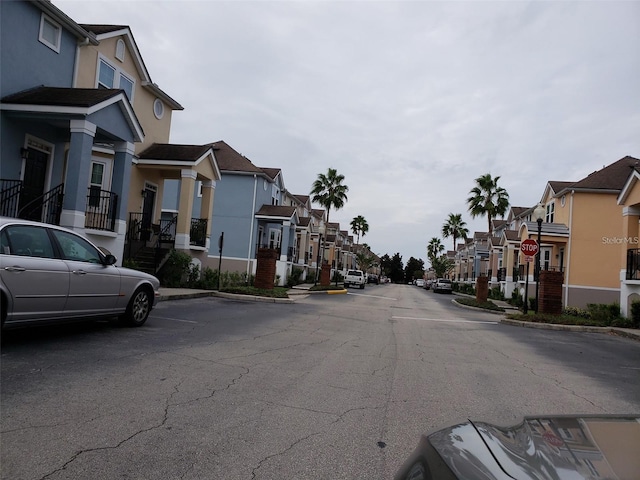 view of street with a residential view, curbs, and sidewalks