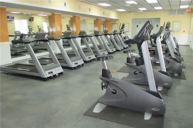 exercise room with a paneled ceiling