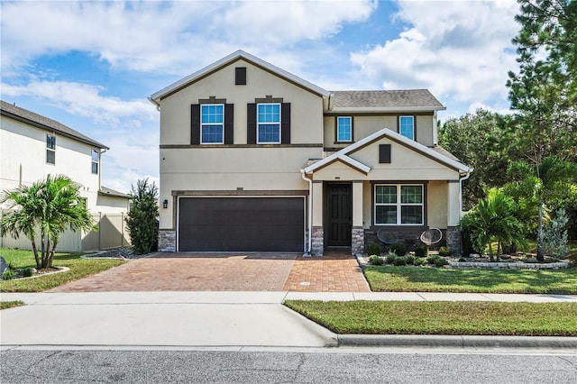 view of front of property with a garage and a front lawn