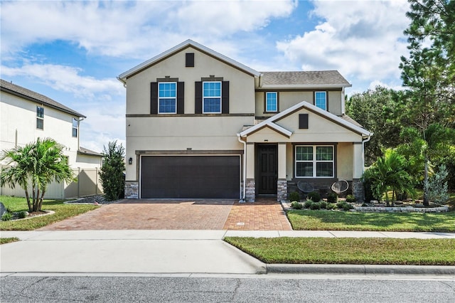 view of front of property featuring a front lawn and a garage