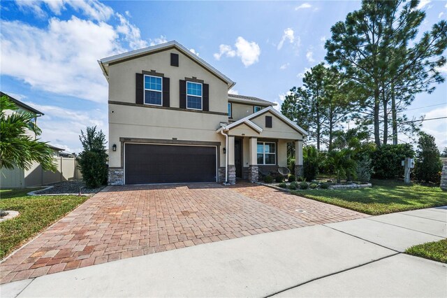 view of front of home featuring a garage and a front yard