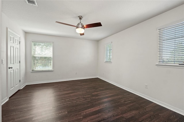 spare room featuring ceiling fan and dark hardwood / wood-style flooring