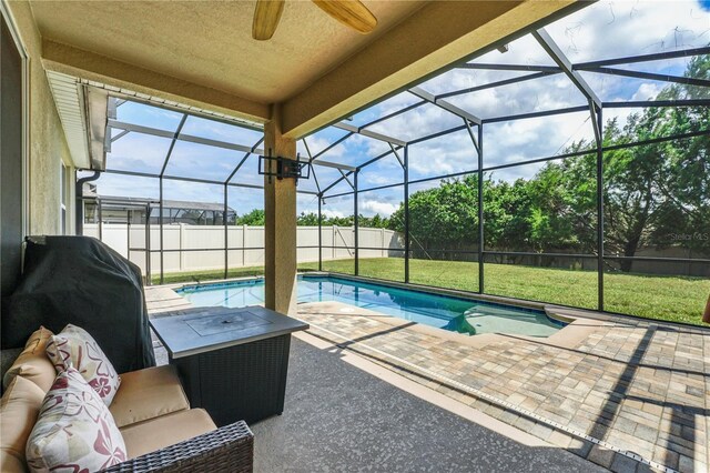 view of pool featuring a patio, area for grilling, ceiling fan, and glass enclosure