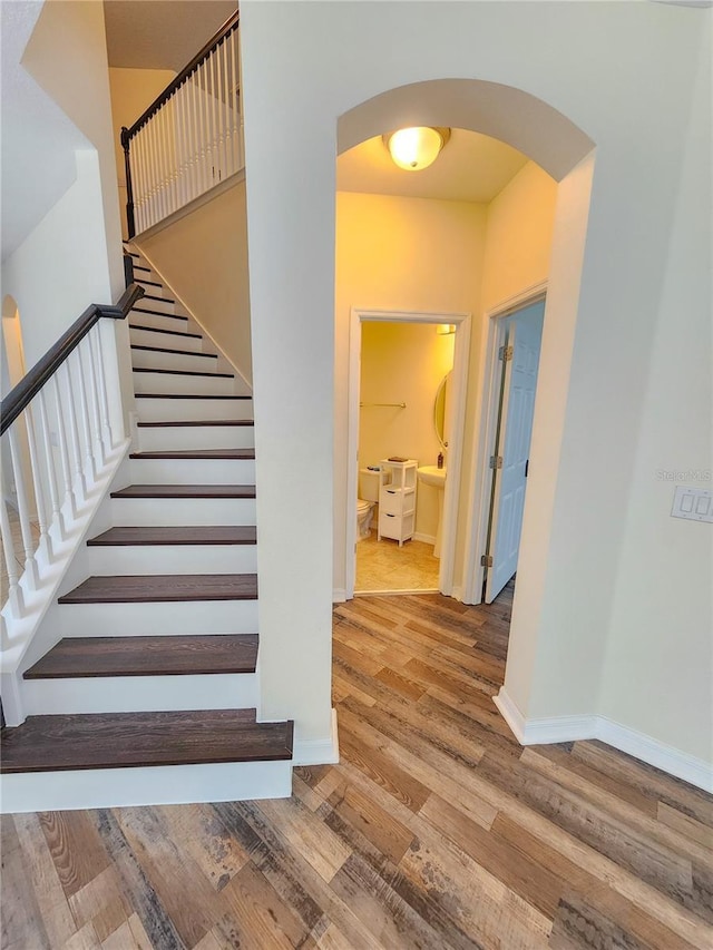 stairway featuring wood-type flooring