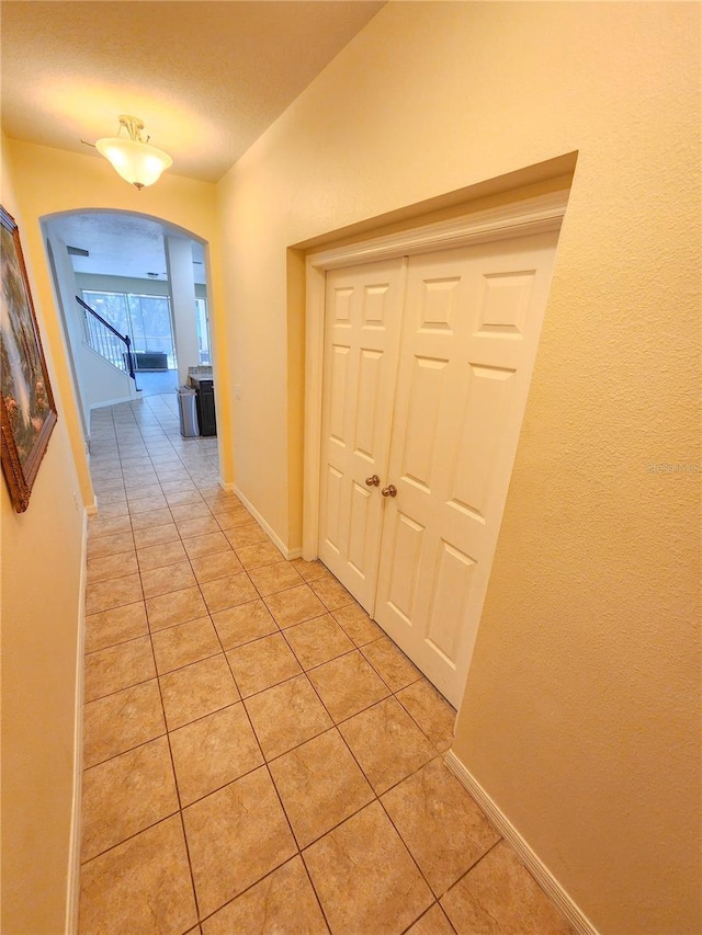 hallway with light tile patterned floors