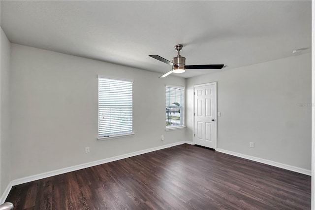 spare room featuring dark wood-type flooring and ceiling fan