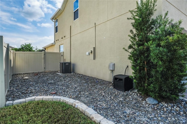 view of side of home featuring central AC unit